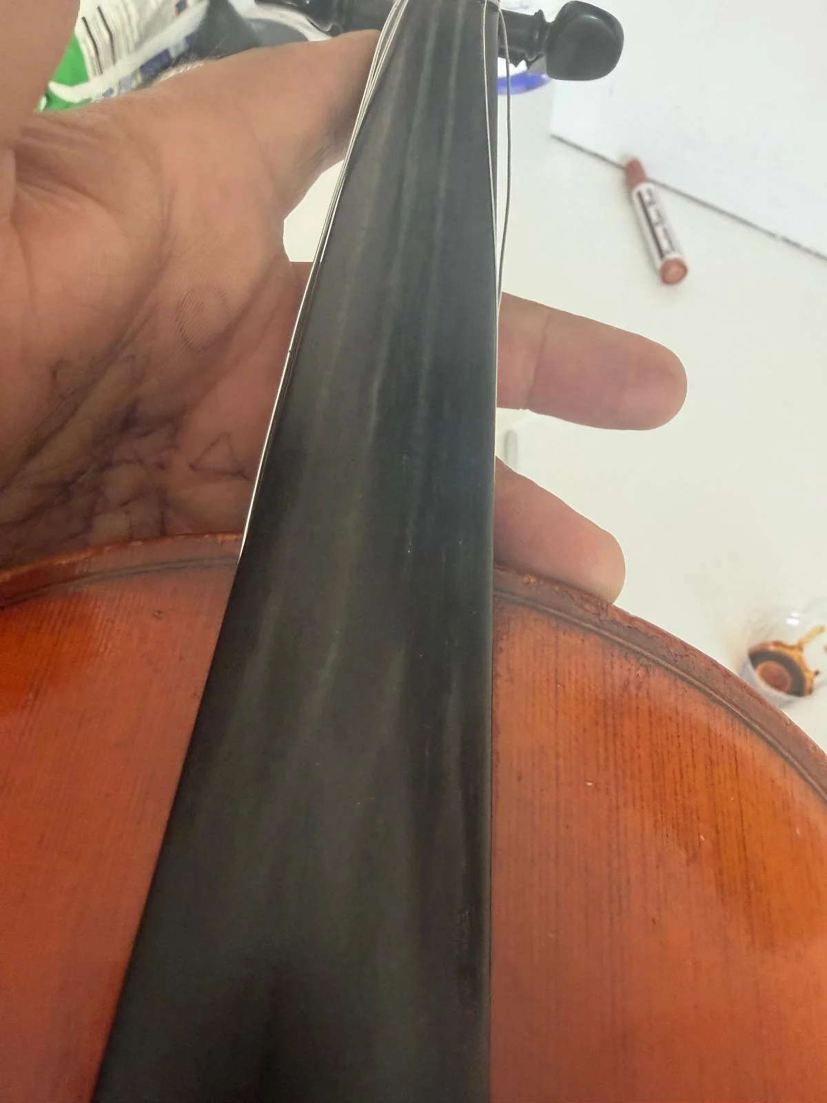 Worn fingerboard before dressing with visible grooves