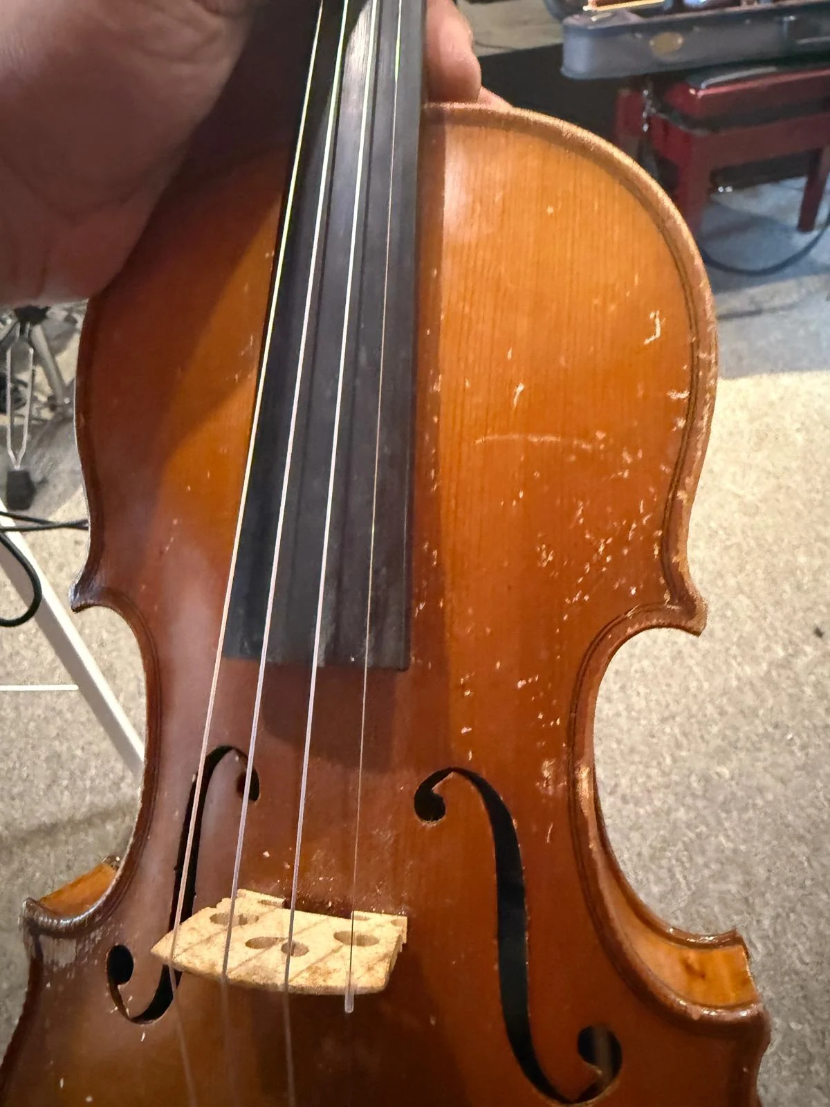 Violin with worn and scratched varnish before repair