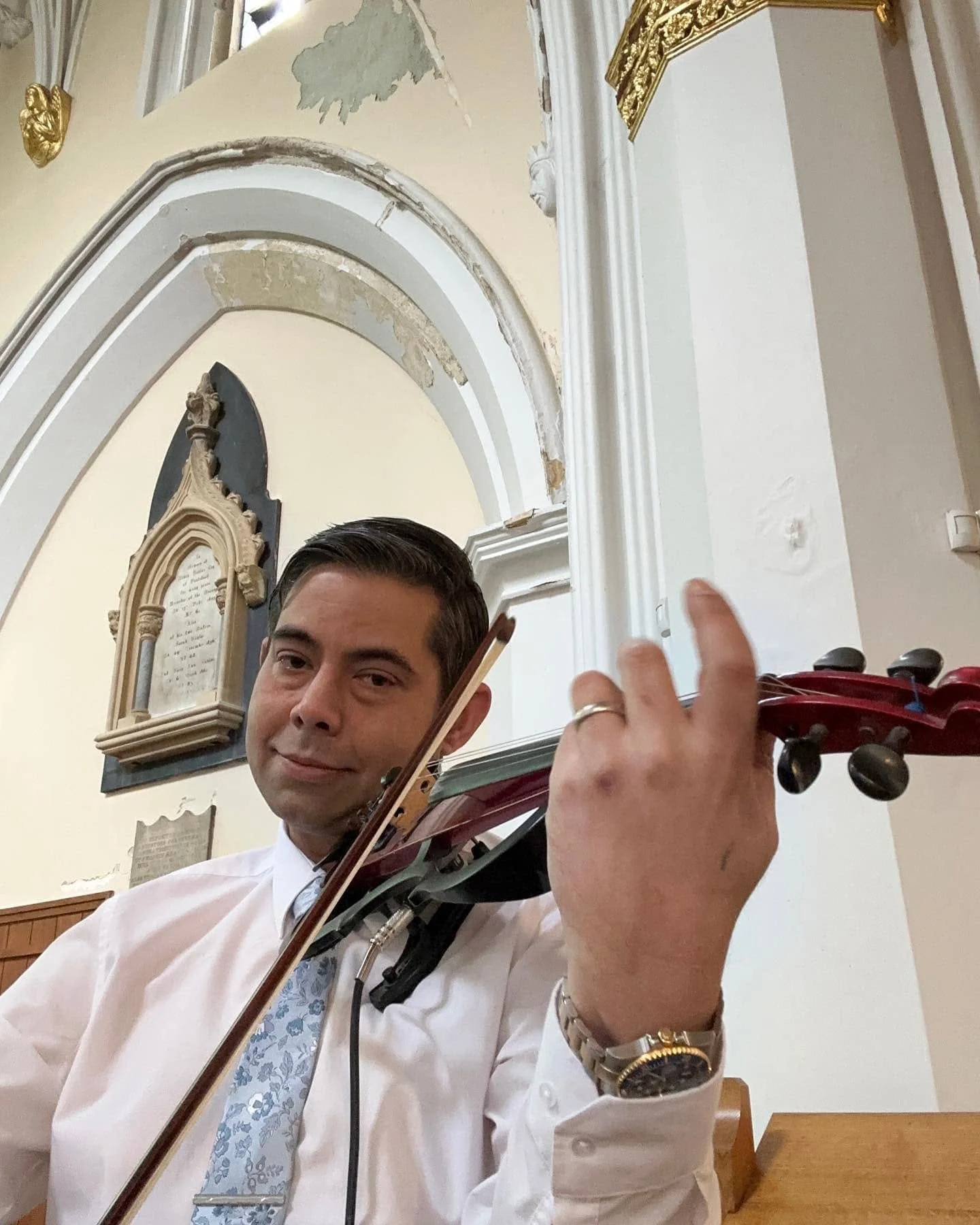 James Taylor performing electric violin in a church