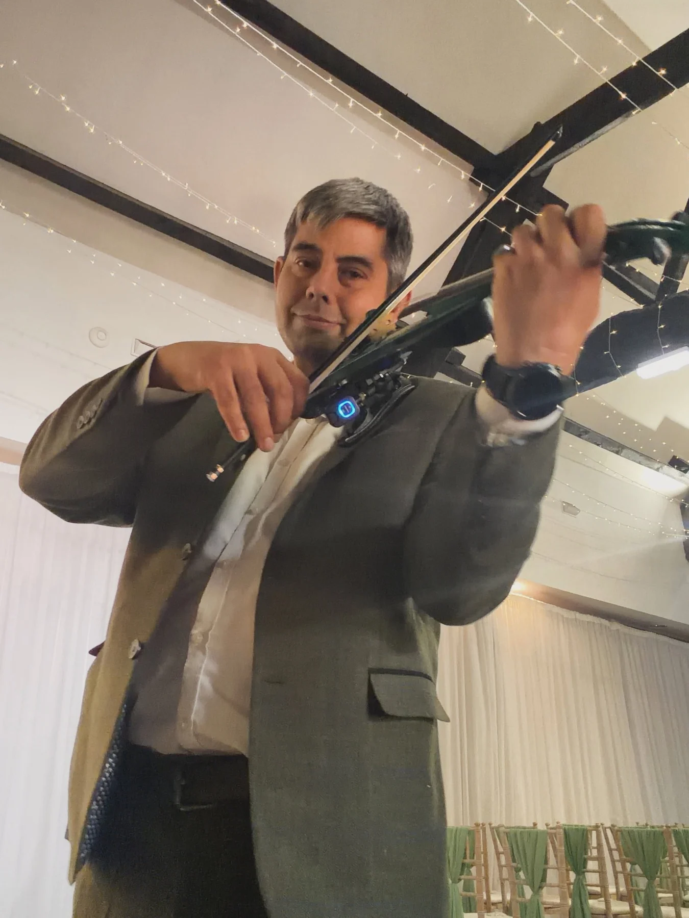 James Taylor performing violin at a formal event