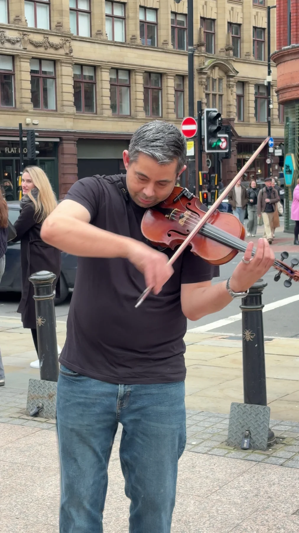 James Taylor performing violin outdoors in the city
