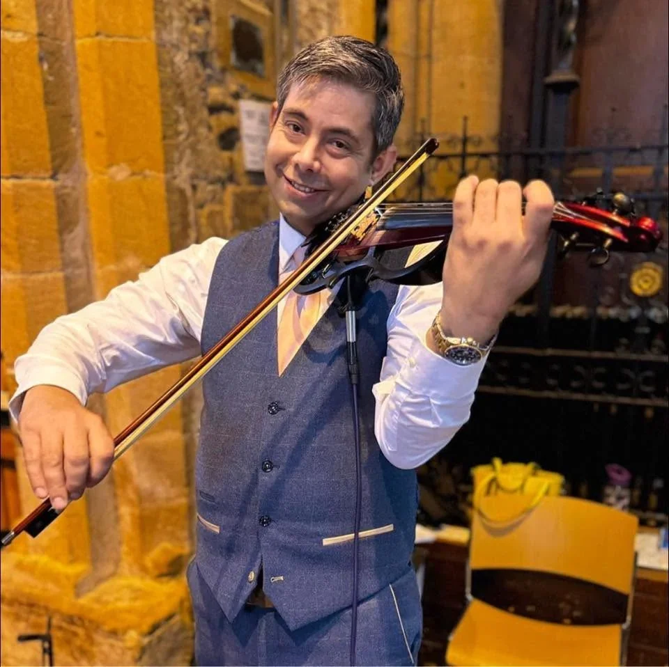 James Taylor performing electric violin at a wedding venue