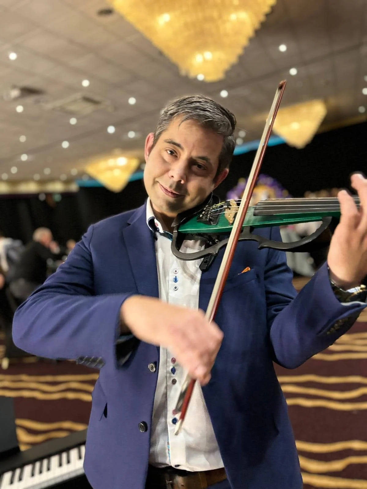 James performing electric violin at a corporate event